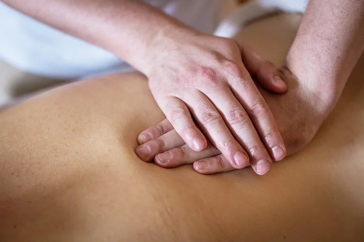 Calm massage treatment room prepared for educational wellness content and client guidance