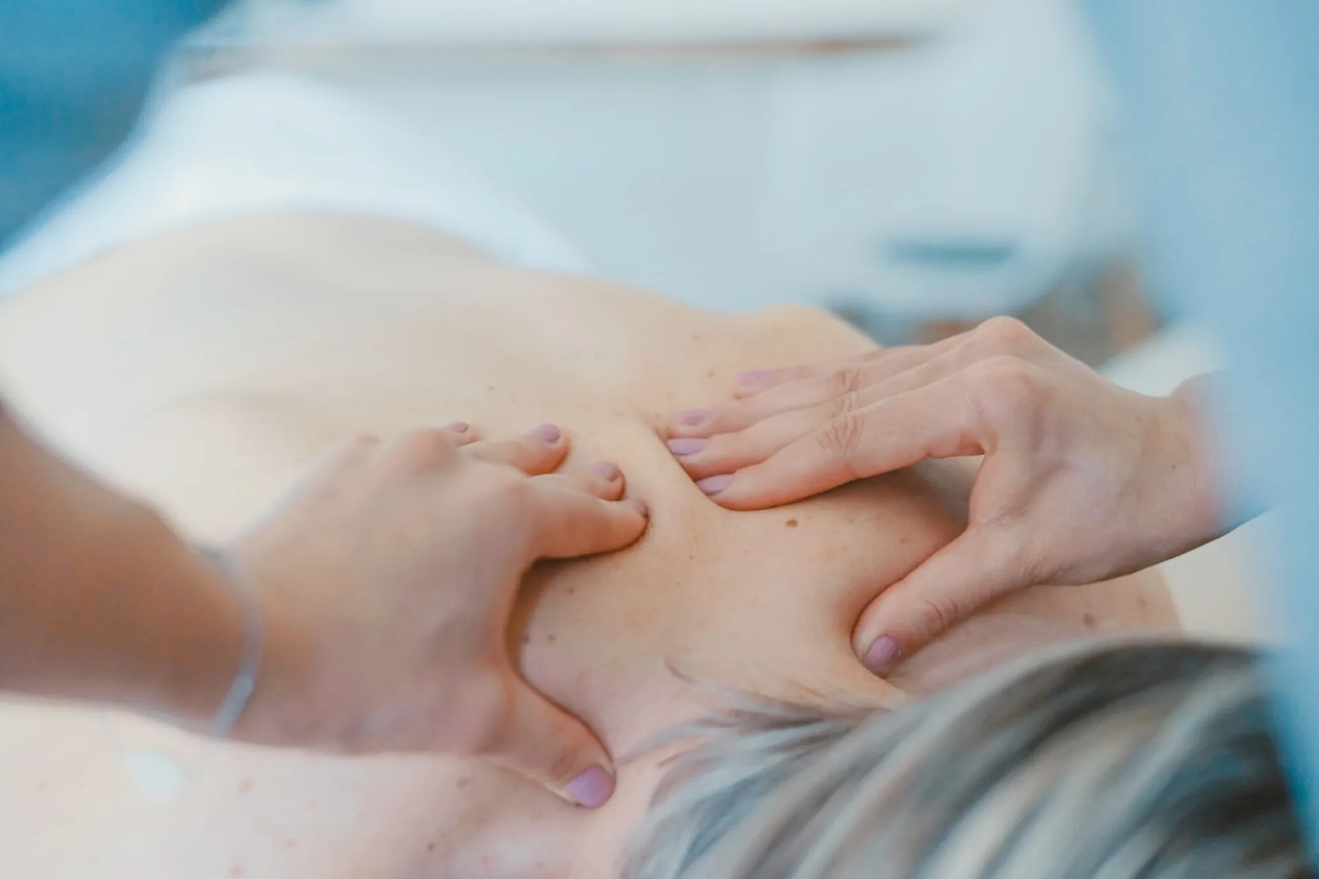 Targeted therapeutic massage technique on upper back and shoulder